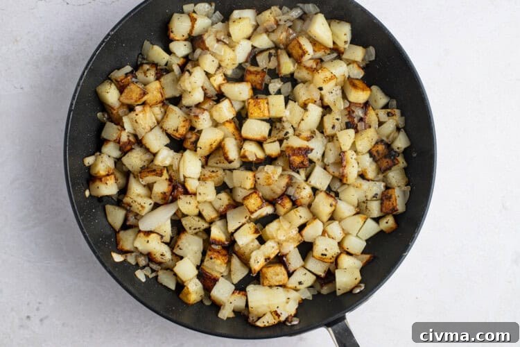 Pan-fried potatoes and onions in large cast iron skillet