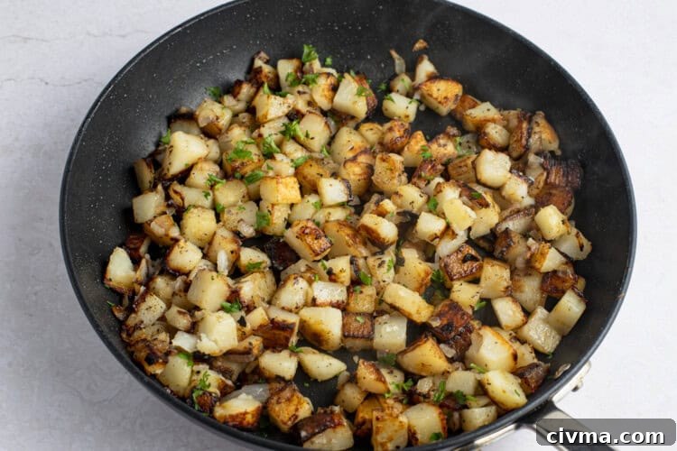 Pan-fried potatoes and onions in large cast iron skillet
