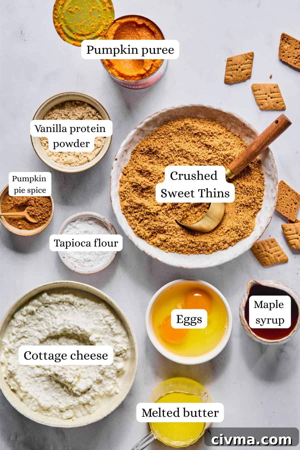 ingredients for pumpkin cheesecake bars in nesting bowls