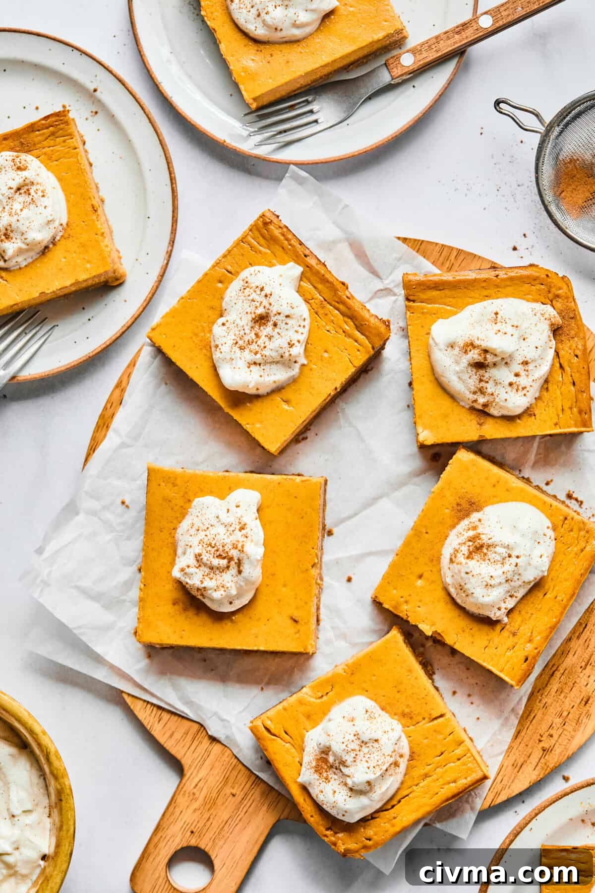 protein pumpkin bars cut up and topped with whipped cream
