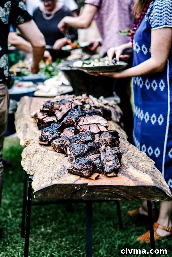 How to Smoke Meat at Home: A Beginner's Guide 4 Side shot of smoked meats on a table at a bbq party.
