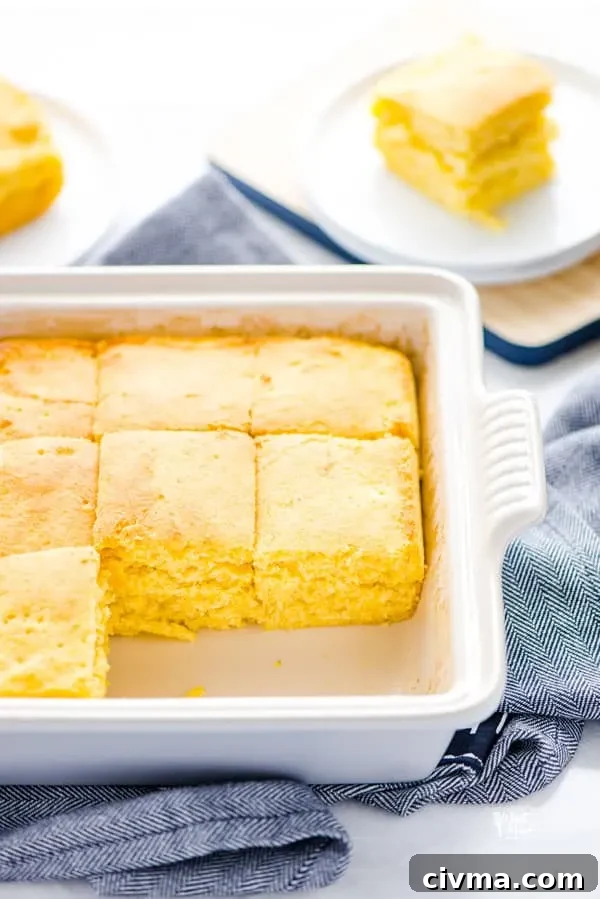Cut gluten free sourdough cornbread in a square baking dish with 2 pieces removed