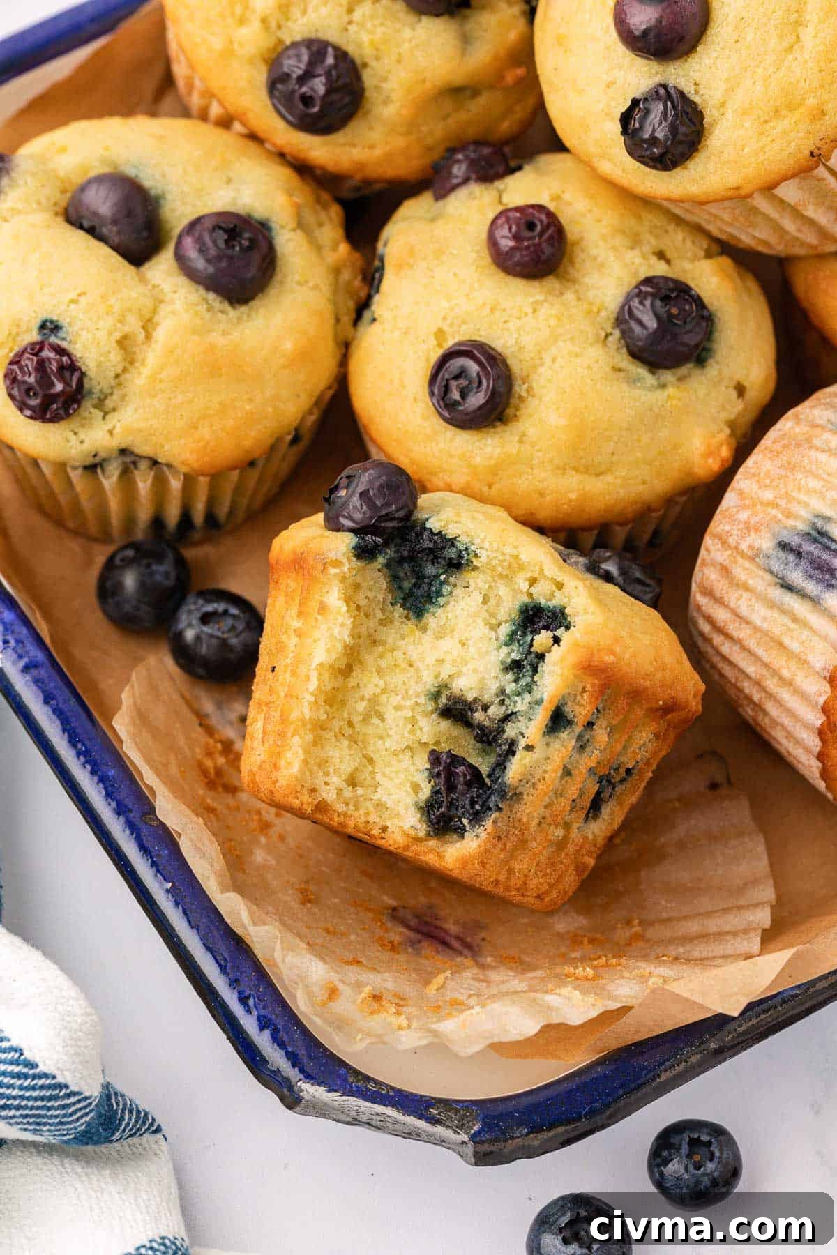 Moist Sour Cream Blueberry Muffins Recipe 2 blueberry muffin with a bite taken out