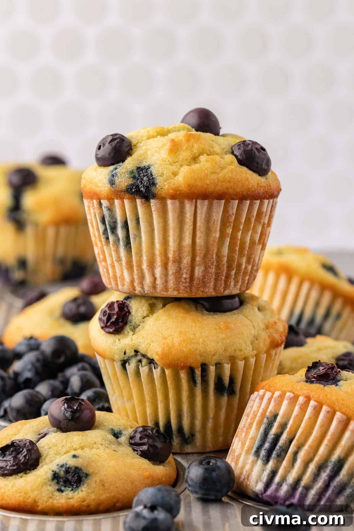Moist Sour Cream Blueberry Muffins Recipe 14 blueberry muffins stacked on top of each other