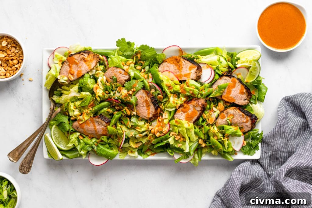Gochujang Pork Tenderloin Salad with Snap Peas and Peanuts (GF) 6 Gochujang grilled pork tenderloin salad on a serving platter.