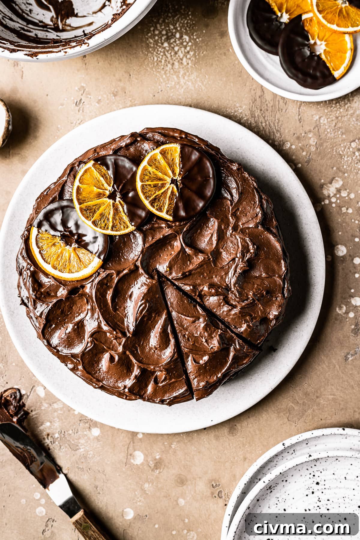A cake with chocolate frosting with one slice cut.