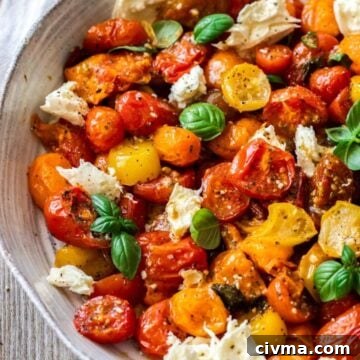 Round grey dish containing Roasted Cherry Tomato Caprese Salad.