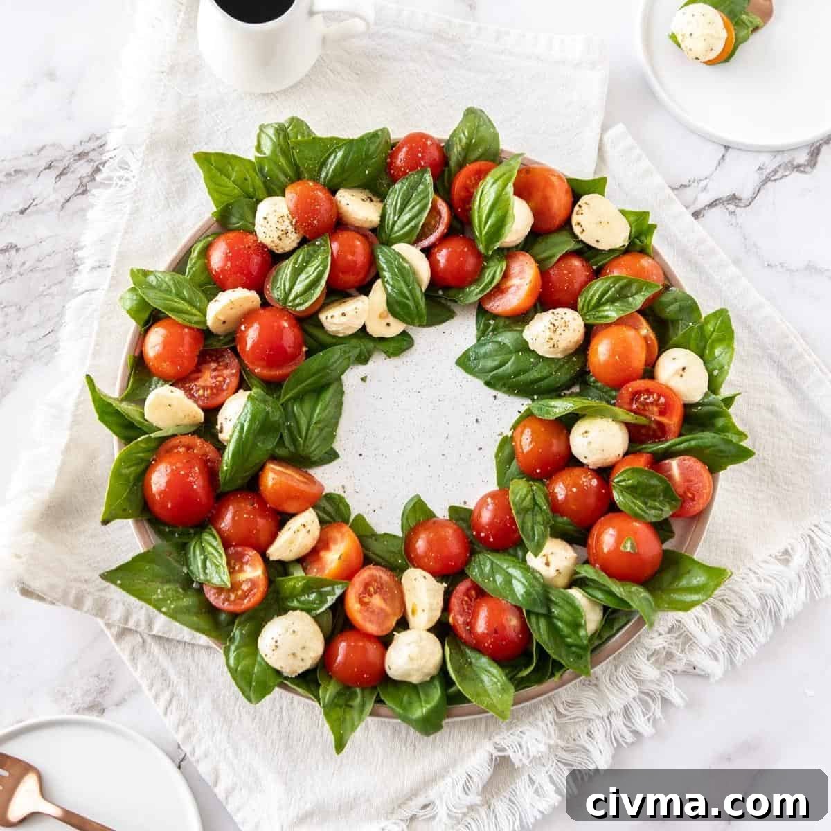 Caprese salad in a wreath circle, on a white plate.