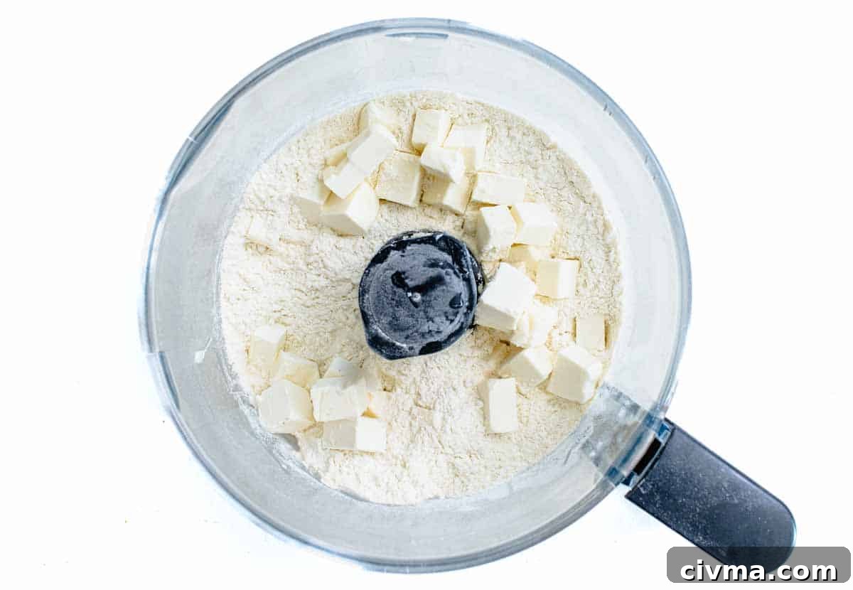 butter cubes and flour in a food processor