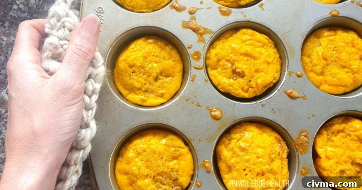 Golden brown muffins in a baking tray.